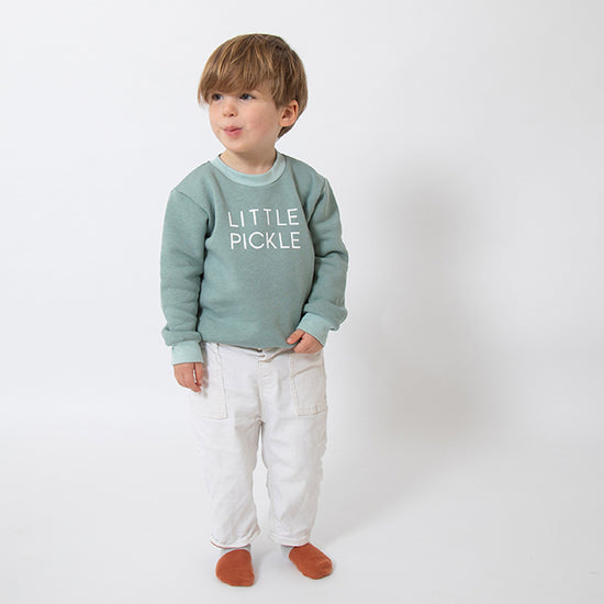 boy wearing a sage sweatshirt with little pickle printed in white